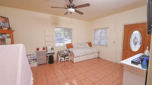 bedroom with light tile patterned floors and a ceiling fan