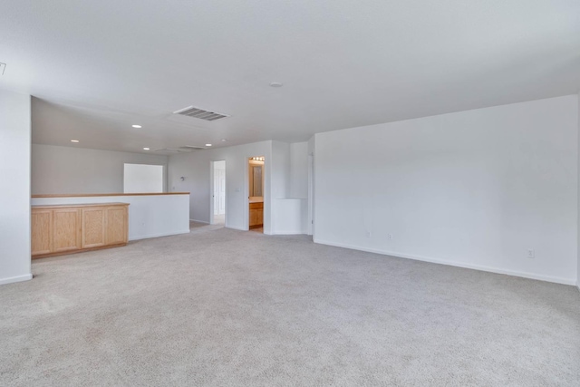 empty room with light carpet, recessed lighting, visible vents, and baseboards