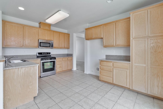 kitchen featuring light tile patterned floors, light brown cabinets, recessed lighting, stainless steel appliances, and a sink