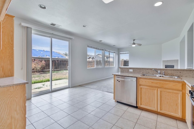 kitchen with a sink, light countertops, and stainless steel dishwasher