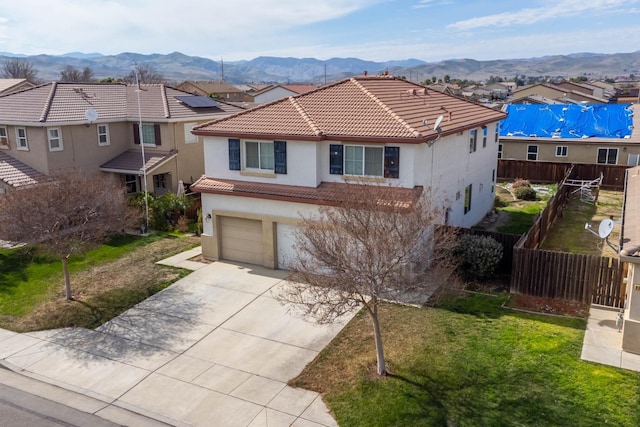 view of front facade with a residential view, a mountain view, a tiled roof, and fence