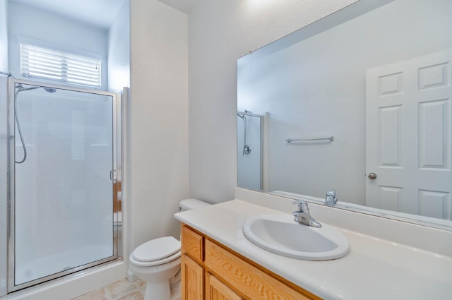 full bathroom featuring vanity, tile patterned flooring, a shower stall, and toilet