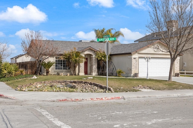 ranch-style home with a garage, fence, concrete driveway, stucco siding, and a front lawn