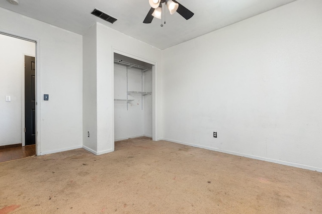 unfurnished bedroom featuring baseboards, visible vents, a ceiling fan, carpet flooring, and a closet