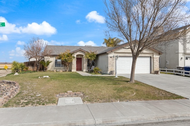 ranch-style home with a front yard, fence, driveway, and an attached garage