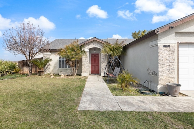 view of front of property featuring stone siding, a front lawn, fence, and stucco siding