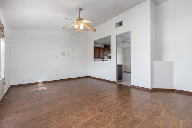 spare room with a ceiling fan, baseboards, visible vents, and dark wood-style flooring