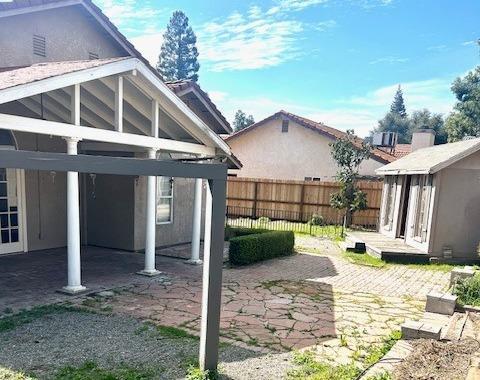 view of yard with an outbuilding, a storage unit, a patio area, and a fenced backyard