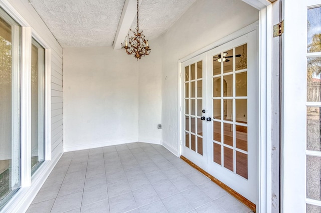 unfurnished sunroom with french doors