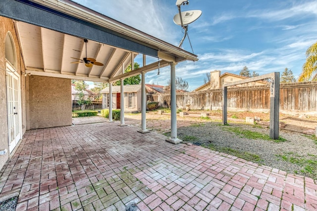 view of patio with ceiling fan, an outdoor structure, and a fenced backyard