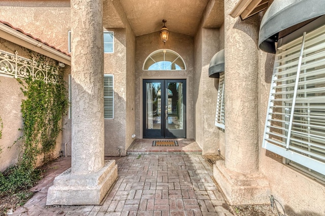 property entrance featuring french doors and stucco siding