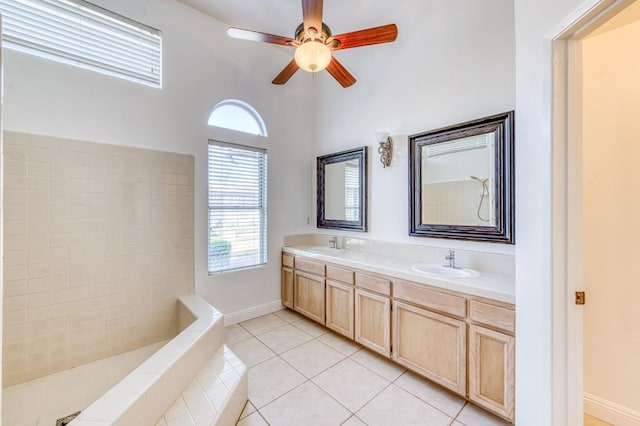 full bath featuring ceiling fan, double vanity, a sink, and tile patterned floors