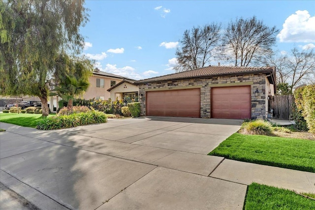 view of front of property with stone siding, a tile roof, concrete driveway, and stucco siding