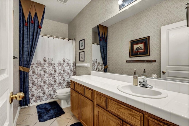 bathroom with wallpapered walls, toilet, vanity, a shower with curtain, and tile patterned floors