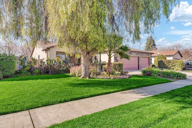 view of front of house with a garage, driveway, a tiled roof, stucco siding, and a front lawn