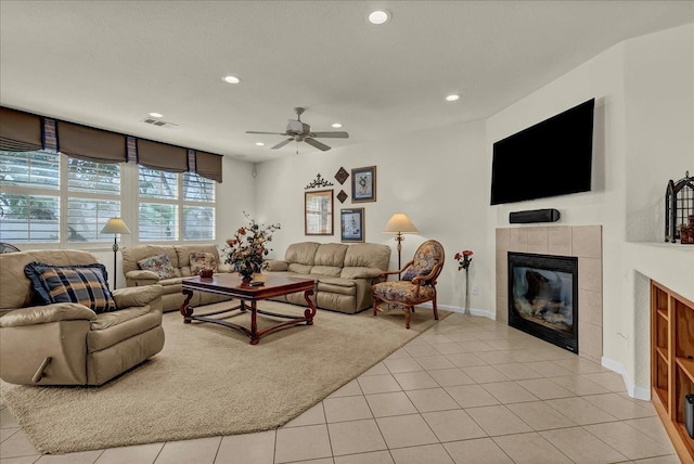 living room with recessed lighting, visible vents, a fireplace, and light tile patterned floors