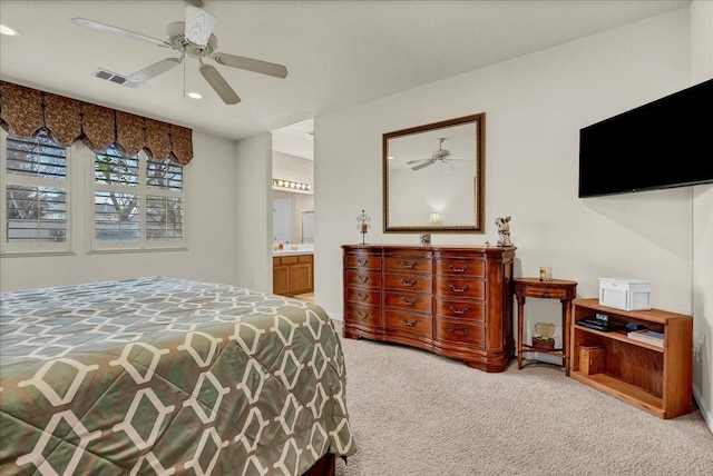 carpeted bedroom with ensuite bathroom, a ceiling fan, visible vents, and recessed lighting