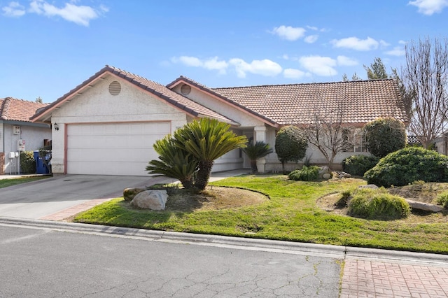 view of front of property with a tiled roof, stucco siding, driveway, and a garage