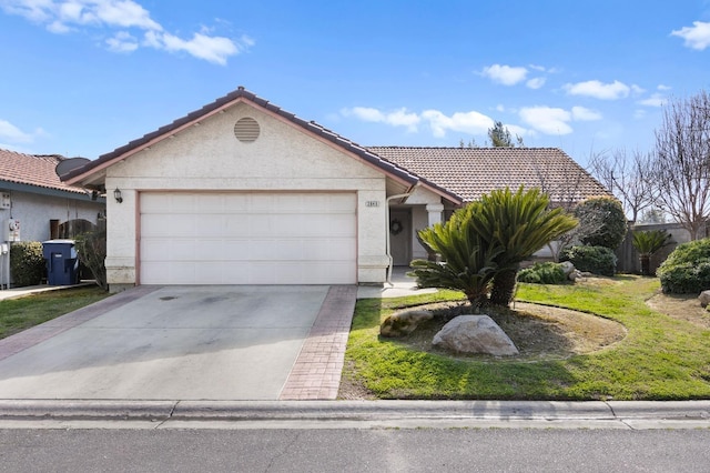 single story home with concrete driveway, a tiled roof, a garage, and stucco siding