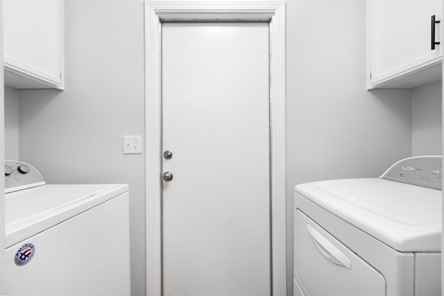 clothes washing area with cabinet space and washer and dryer