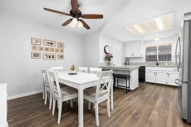 dining room featuring ceiling fan, dark wood-type flooring, and baseboards