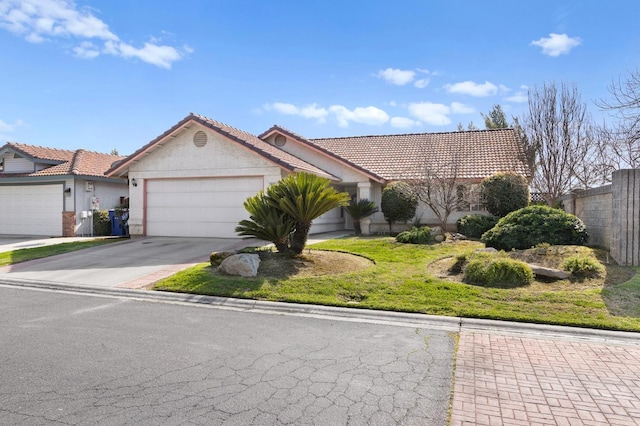 view of front of property featuring concrete driveway, a tiled roof, an attached garage, and stucco siding