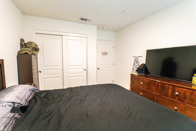 bedroom featuring a closet and visible vents