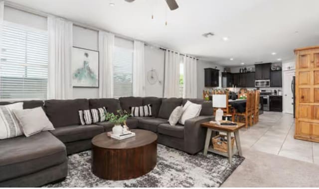 living area featuring a ceiling fan, light tile patterned floors, and recessed lighting