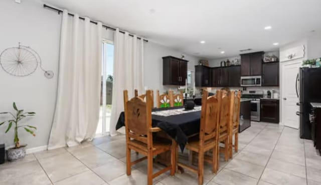 dining room featuring light tile patterned flooring and recessed lighting