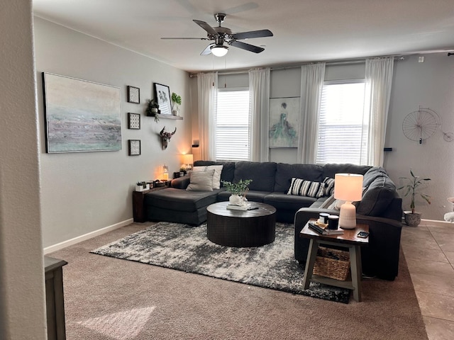 living room with a ceiling fan, a wealth of natural light, and baseboards