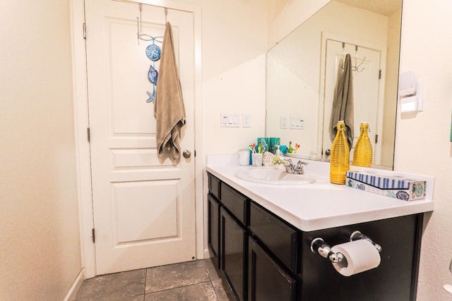 bathroom with stone finish floor, vanity, and baseboards