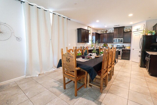 dining space with recessed lighting and light tile patterned flooring