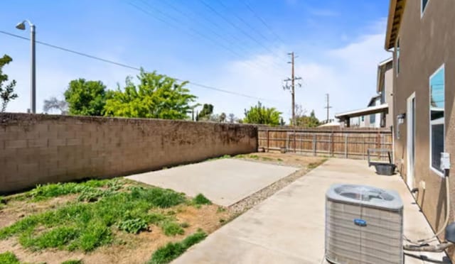 view of patio / terrace featuring a fenced backyard and central AC