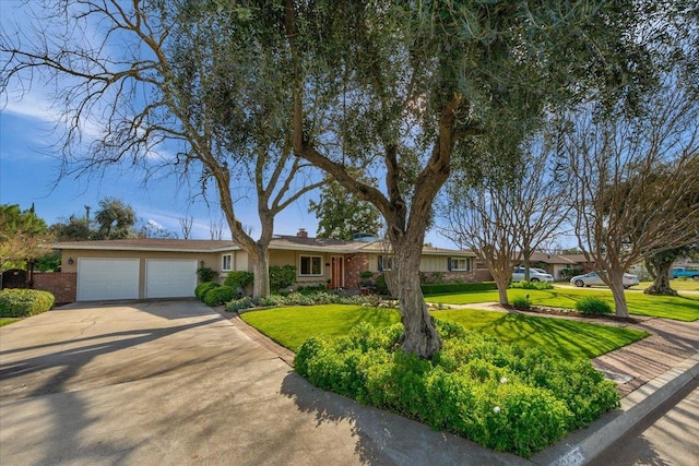 single story home with a garage, a front yard, concrete driveway, and brick siding