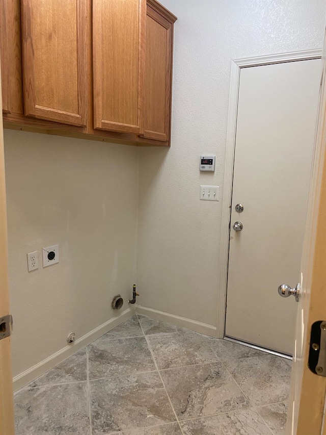 laundry area with cabinet space, electric dryer hookup, gas dryer hookup, and baseboards