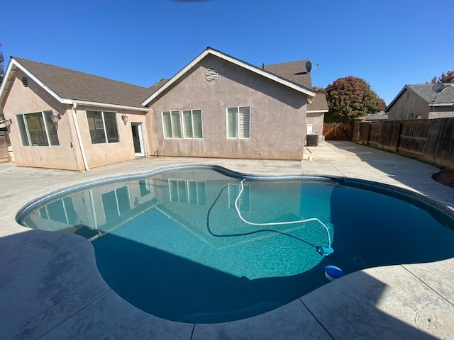 view of swimming pool featuring a patio, central AC unit, a fenced backyard, and a fenced in pool