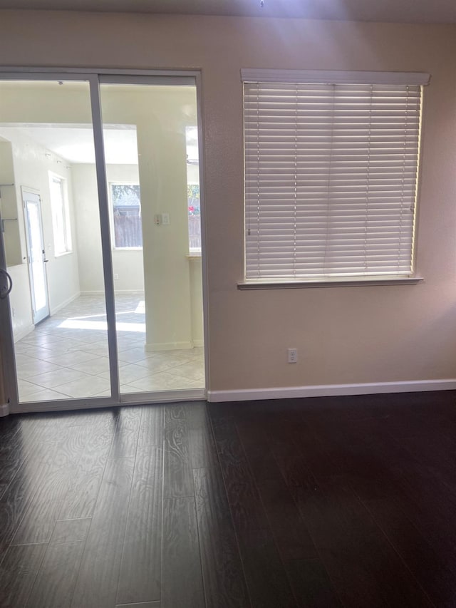 unfurnished room featuring wood finished floors and baseboards