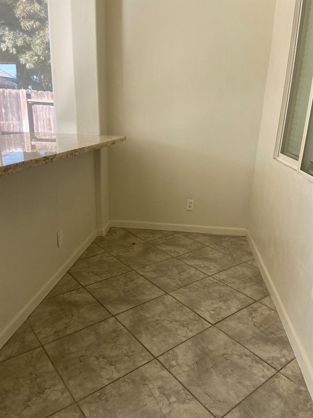 spare room featuring baseboards