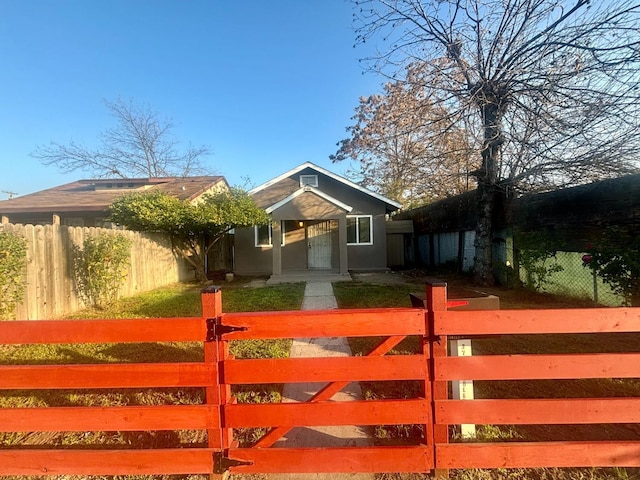 view of gate featuring a fenced front yard