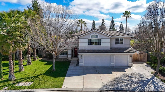 traditional home featuring a garage, a tiled roof, fence, a front lawn, and stucco siding