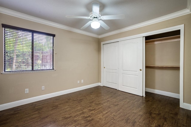 unfurnished bedroom featuring baseboards, a closet, ornamental molding, and dark wood-type flooring