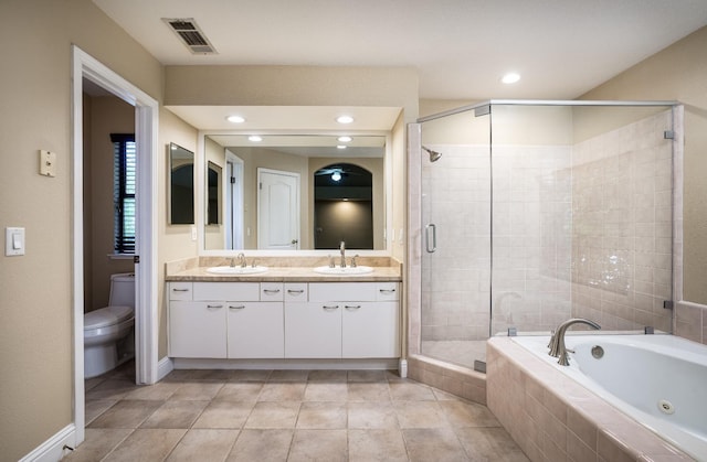 full bath with visible vents, a sink, a shower stall, and a bath