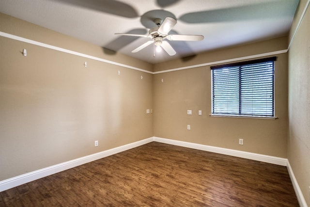 empty room featuring wood finished floors, a ceiling fan, and baseboards