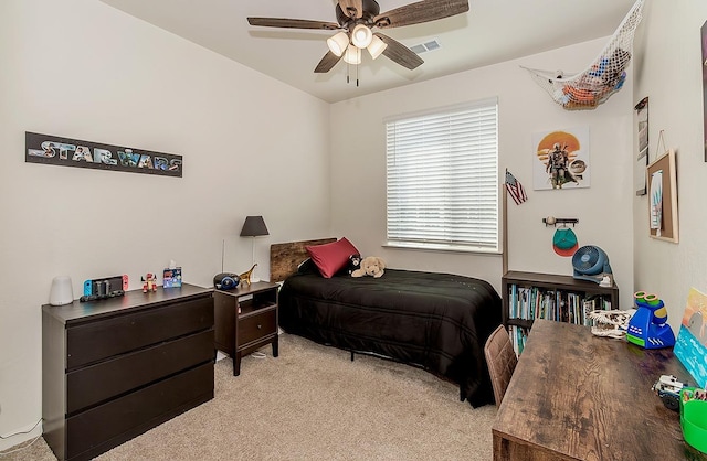 bedroom featuring light colored carpet, ceiling fan, and visible vents