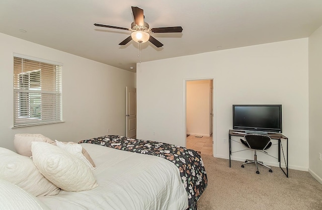 bedroom featuring baseboards, a ceiling fan, and light colored carpet