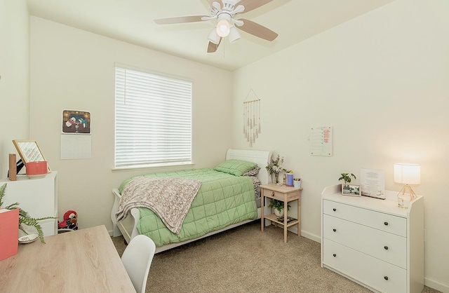 bedroom with ceiling fan, baseboards, and light colored carpet