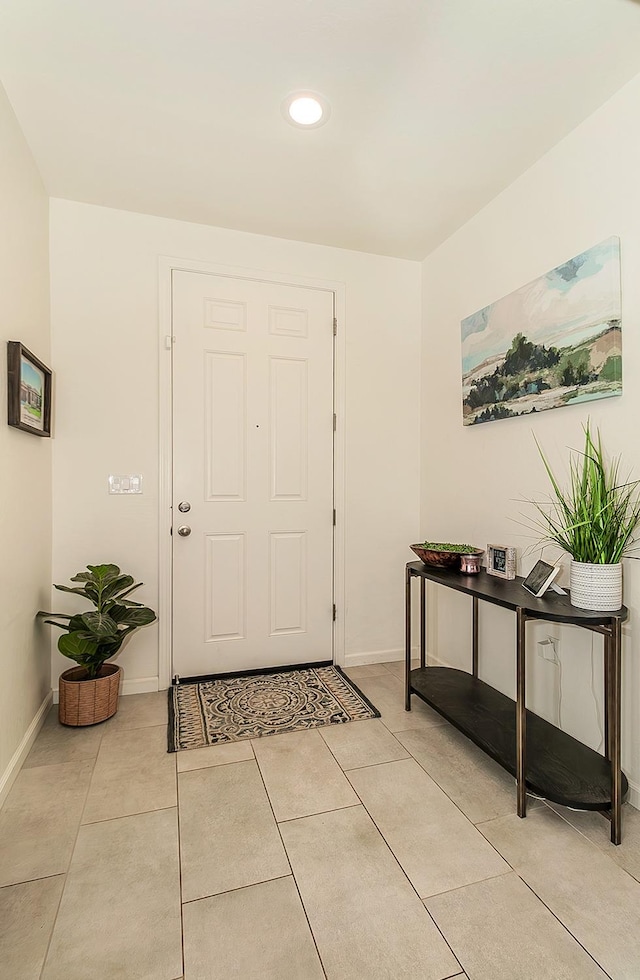 entryway with recessed lighting, light tile patterned flooring, and baseboards