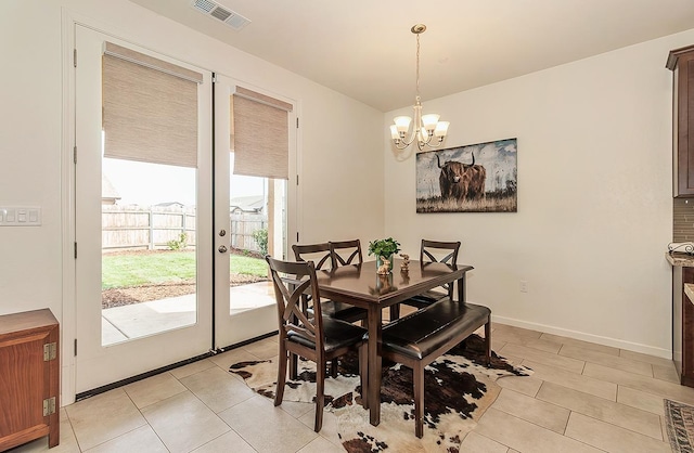 dining space featuring light tile patterned floors, baseboards, visible vents, an inviting chandelier, and french doors