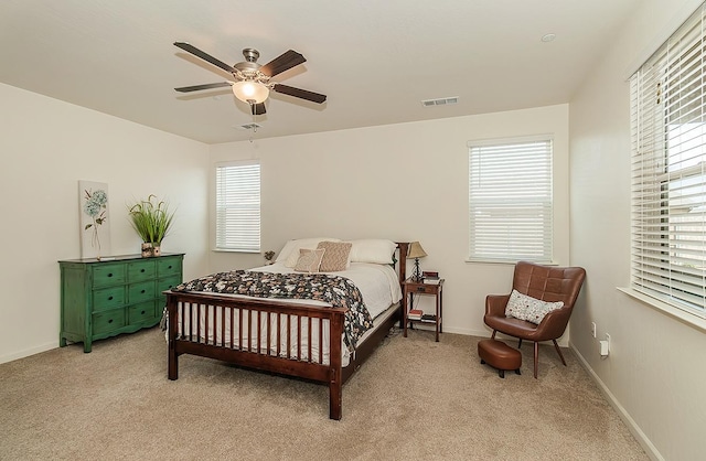 bedroom featuring visible vents, ceiling fan, light carpet, and baseboards