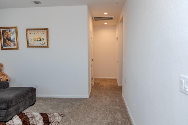 interior space featuring light carpet, baseboards, visible vents, and recessed lighting